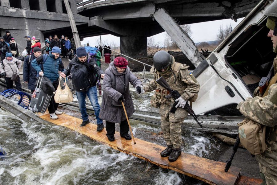 IRPIN%2C+UKRAINE+-+MARCH+07%3A+Residents+of+Irpin+flee+heavy+fighting+via+a+destroyed+bridge+as+Russian+forces+entered+the+city+on+March+07%2C+2022+in+Irpin%2C+Ukraine.+Yesterday%2C+four+civilians+were+killed+by+mortar+fire+along+the+road+leading+from+Irpin+to+Kyiv%2C+which+has+been+a+key+evacuation+route+for+people+fleeing+Russian+forces+advancing+from+the+north.+Today%2C+Ukraine+rejected+as+unacceptable+a+Russian+proposal+for+a+humanitarian+corridor+that+leads+from+Kyiv+to+Belarus%2C+a+Russian+ally+that+was+a+staging+ground+for+the+invasion.+%28Photo+by+Chris+McGrath%2FGetty+Images%29